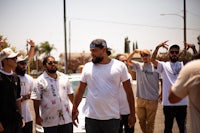 a group of people standing in a street